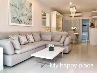 a living room with a couch and a table at My Happy Place in Nonthaburi