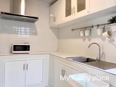 a white kitchen with a sink and a microwave at My Happy Place in Nonthaburi
