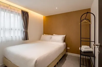 a small bedroom with a bed and a window at CJ ELAND Sukhumvit36 BTS Thonglor in Khlong Toei