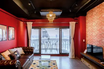 a living room with a couch and a table at Best river view - Loft apartment in great location in Bangkok