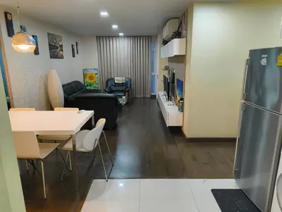 a living room with a table and a refrigerator at بانكوك سوكمفيت شارع 5 liv at 5 in Bangkok