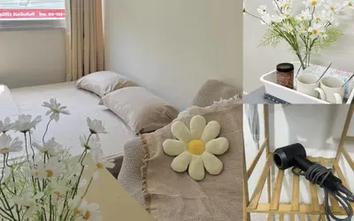 a bedroom with a bed with a flower on it at Happy Daisy ห้องพัก เมืองทองธานี in Nonthaburi