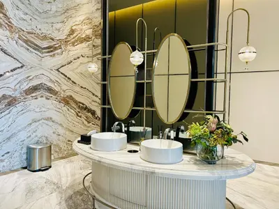 a bathroom with three sinks and mirrors on a counter at The Address Siam Luxury Two Bedrooms in Bangkok