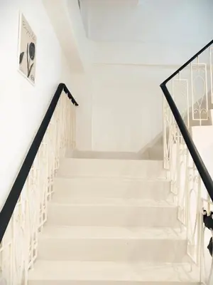 a staircase in a house with white walls and black railings at Fivehouse Silom2 soi11 City heart Silom BTS 7min in Bang Rak