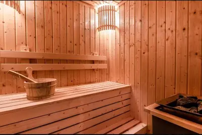 a wooden sauna with a bucket on a shelf at BTS Thonglor - Serene Japanese-style Haven, Onsen in Bangkok