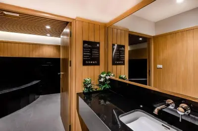 a bathroom with a sink and a large mirror at BTS Thonglor - Serene Japanese-style Haven, Onsen in Bangkok