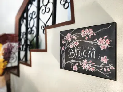 a chalkboard sign that says youre in full bloom on a wall at Asokes Hidden Gem Cozy Stay Next to the Park in Bangkok