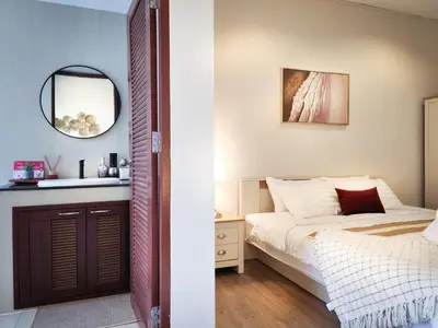 a bedroom with a bed and a mirror at Asokes Hidden Gem Cozy Stay Next to the Park in Bangkok
