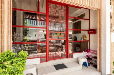 a window of a restaurant with a red frame at 1137 Hostel in Bangkok