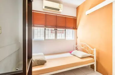 a small room with a bed and a window at 1137 Hostel in Bangkok