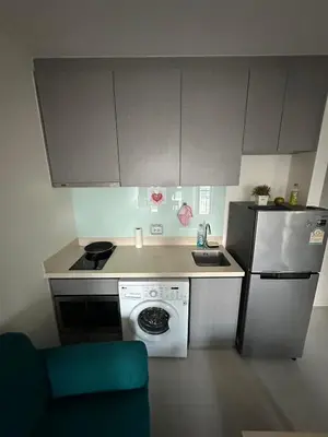 a small kitchen with a stove and a refrigerator at Thong Lor, Sukhumvit 36 in Bangkok