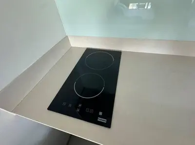 a black stove top on a counter in a kitchen at Thong Lor, Sukhumvit 36 in Bangkok