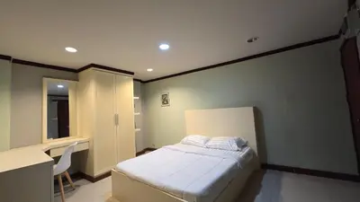 a bedroom with a bed and a desk and a desk at The Haven Sabi in Bangkok