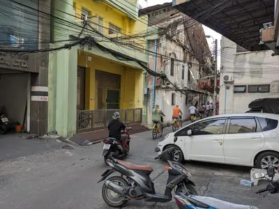a group of people riding motorcycles on a city street at The Haven Sabi in Bangkok