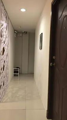 a hallway with a door and a tile floor at The Haven Sabi in Bangkok