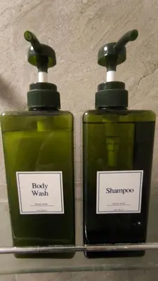 two bottles of soap sitting next to each other at Silom room 40 sqm with 2 Queen beds for 4 persons in Bangkok