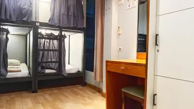 a dressing room with two mirrors and a dresser at The LODGE BKK Hostel in Bangkok
