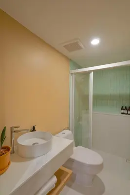 a bathroom with a toilet and a sink and a shower at Naiya Bangkok in Bangkok