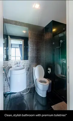 a bathroom with a toilet and a sink and a shower at Luxurious Upscale Downtown Apartment in Bangkok
