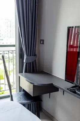 a desk in a hotel room with a window at Luxurious Upscale Downtown Apartment in Bangkok
