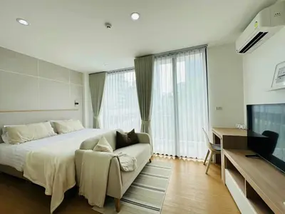 a bedroom with a bed and a couch and a television at 6th Avenue Sukhumvit BKK 308 BTS Asoke & Nana MRT Sukhumvit in Bang Kapi