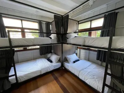 a group of bunk beds in a room at Green Cabin Hostel in Bangkok