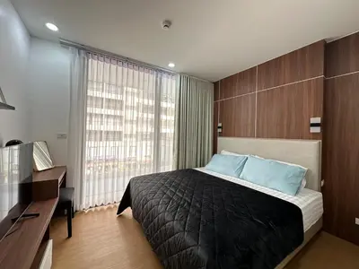 a bedroom with a bed and a desk and a window at 6th Avenue Sukhumvit 305 BTS Asoke & Nana MRT Sukhumvit in Bang Kapi