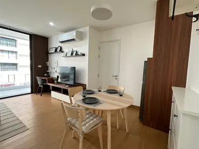 a kitchen and living room with a table and a desk at 6th Avenue Sukhumvit 305 BTS Asoke & Nana MRT Sukhumvit in Bang Kapi