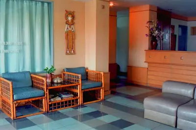 a living room with two chairs and a couch at R Lodge in Bangkok