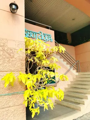 a plant with yellow leaves next to a staircase at R Lodge in Bangkok