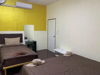 two beds in a room with two hats on them at The House Hostel 2 in Bangkok
