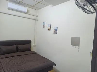 a bedroom with a bed and pictures on the wall at The House Hostel 2 in Bangkok