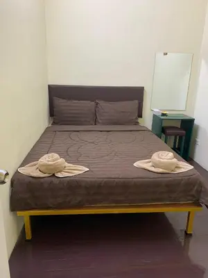 two hats are sitting on a bed in a room at The House Hostel 2 in Bangkok