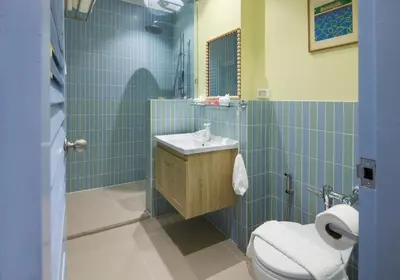 a bathroom with a sink and a toilet at Kitsch Hotel in Bangkok