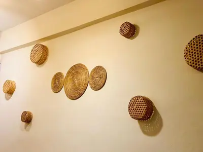 a group of gold coins hanging on a wall at Charming Hostel in Bangkok