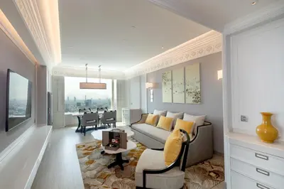 a living room with a couch and a table at Grande Centre Point Lumphini Bangkok in Bangkok