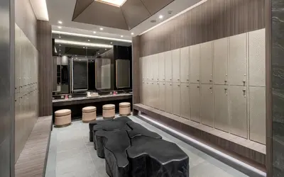 a bathroom with a black stool in the middle at Grande Centre Point Lumphini Bangkok in Bangkok