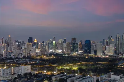 a city skyline at night with lit up buildings at Grande Centre Point Lumphini Bangkok in Bangkok
