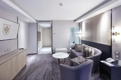 a living room with two couches and a table at Grace Hotel in Bangkok