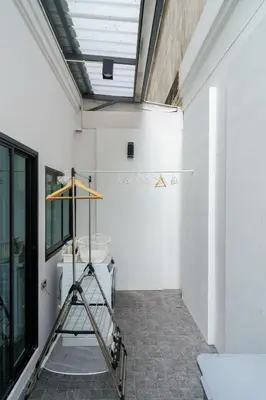 a room with a ladder next to a white wall at Cozy Spacious 4BR Villa, 12pax, 200m BTS PhraKhanong, 10min ThongLo, Fast 500mbps Wifi in Bangkok