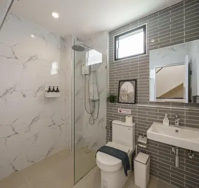 a bathroom with a shower and a toilet and a sink at Cozy Spacious 4BR Villa, 12pax, 200m BTS PhraKhanong, 10min ThongLo, Fast 500mbps Wifi in Bangkok