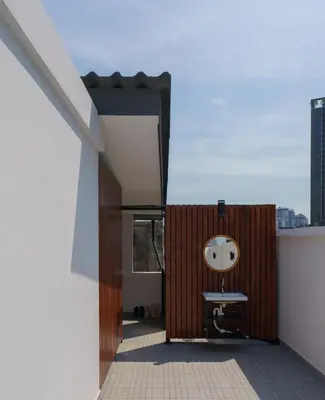 a bathroom with a round mirror on a balcony at Cozy Spacious 4BR Villa, 12pax, 200m BTS PhraKhanong, 10min ThongLo, Fast 500mbps Wifi in Bangkok