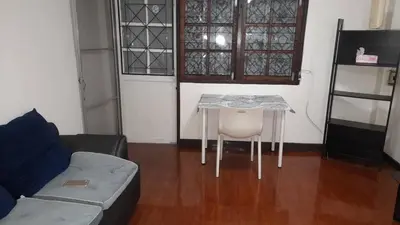 a living room with a table and a couch at Sirin Home in Bangkok