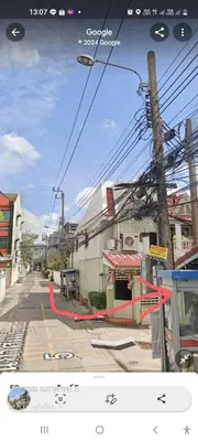 a picture of a street with a building with a red ribbon at Sirin Home in Bangkok