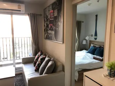 a bedroom with a couch and a bed and a mirror at Cozy Living in Bangkok 60m to MRT near chatuchank in Bang Su