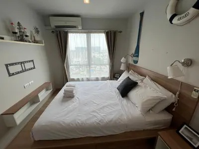 a bedroom with a large white bed with a window at Cozy Living in Bangkok 60m to MRT near chatuchank in Bang Su