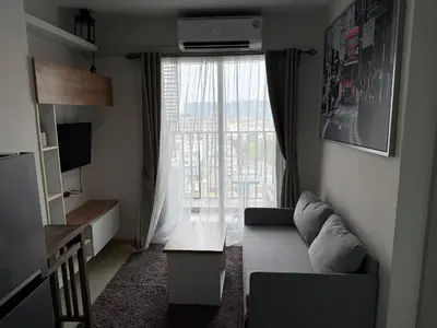 a living room with a couch and a large window at Cozy Living in Bangkok 60m to MRT near chatuchank in Bang Su