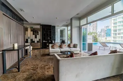 a living room with a couch and a table at Thonglor Area 1 bedroom Check in 24h Fast WiFi 98 in Bangkok