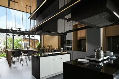 a kitchen with black cabinets and a kitchen island with chairs at \ub77c\uc2fc\ucf58\ub3c4 in Bangna