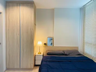 a bedroom with a bed and a cabinet and a television at \ub77c\uc2fc\ucf58\ub3c4 in Bangna